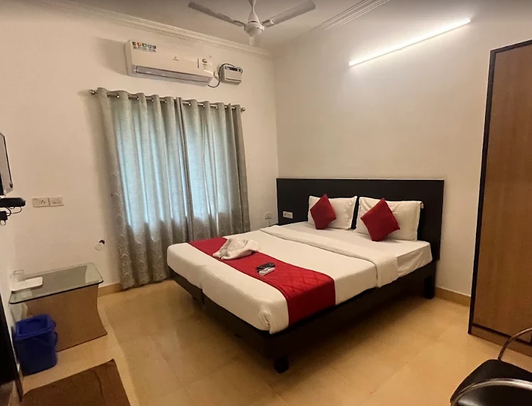Super Deluxe room with red runner and curtains